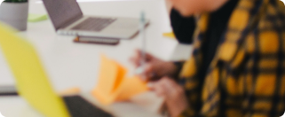 Person writing on a notepad